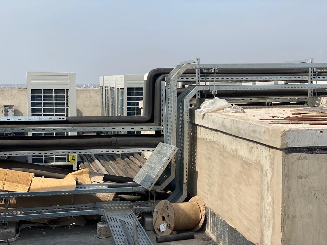 Rooftop refrigerant piping and cable trays installed on a commercial roof