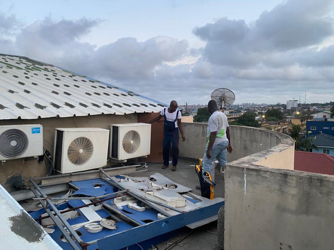 Technicians working on an outdoor electrical panel