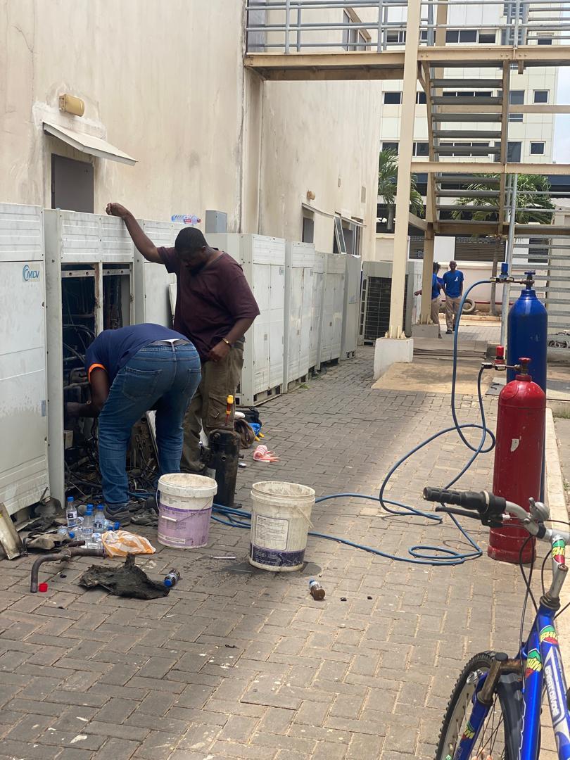 Technicians completing an indoor air conditioning installation